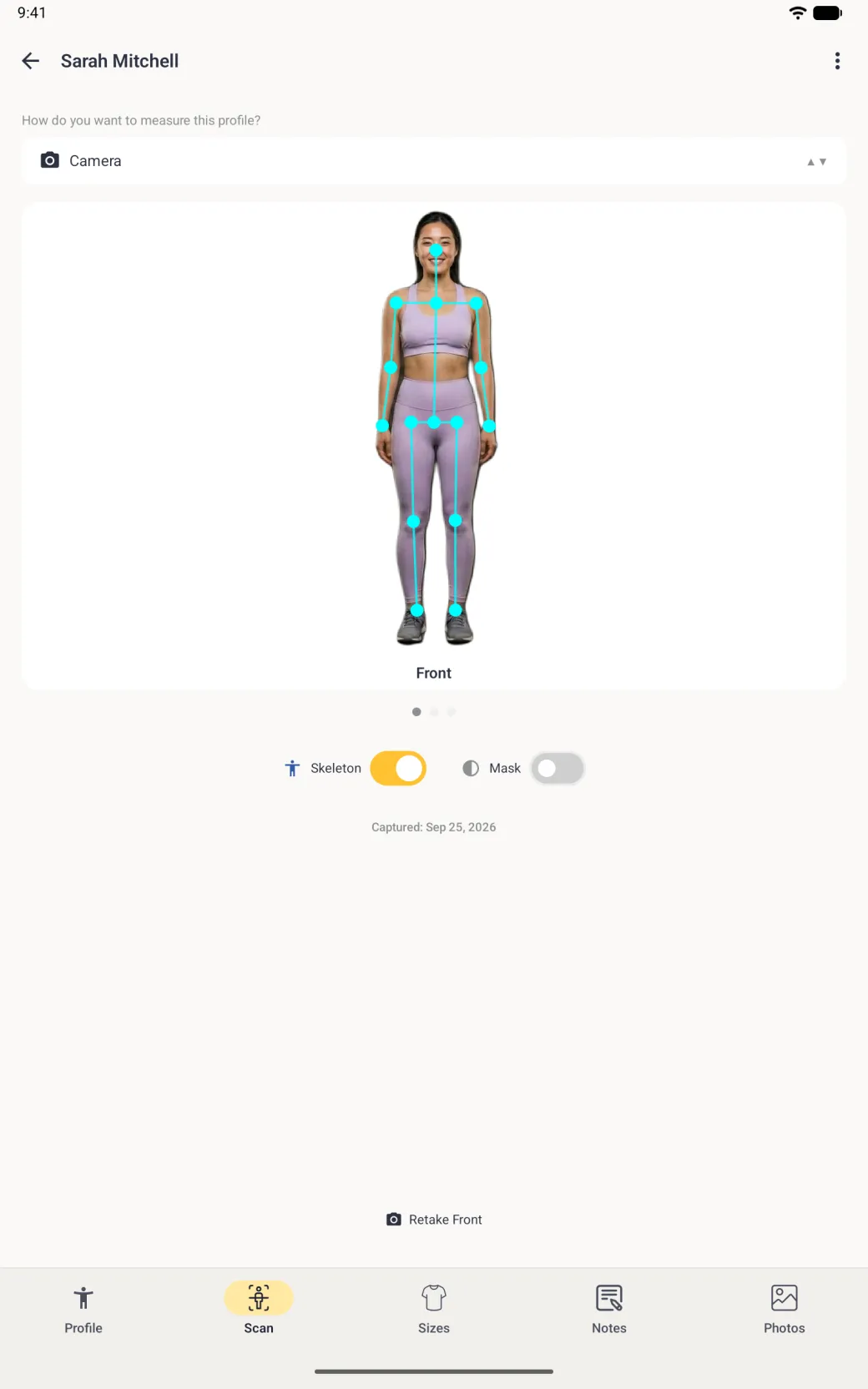 On the full-screen Scan tab of a tablet, the same cut out photo with cyan dots on the nose, shoulders, elbows, wrists, hips, knees and ankles joined by cyan lines, and the Skeleton switch on in gold.