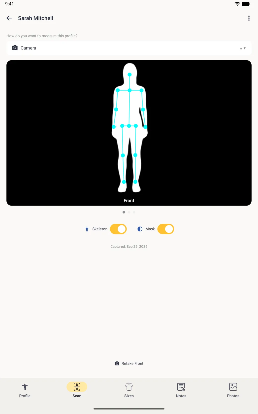 On the full-screen Scan tab of a tablet, a wide black card with a white silhouette of a standing figure and the cyan skeleton over it, labelled Front, with both the Skeleton and Mask switches on in gold.