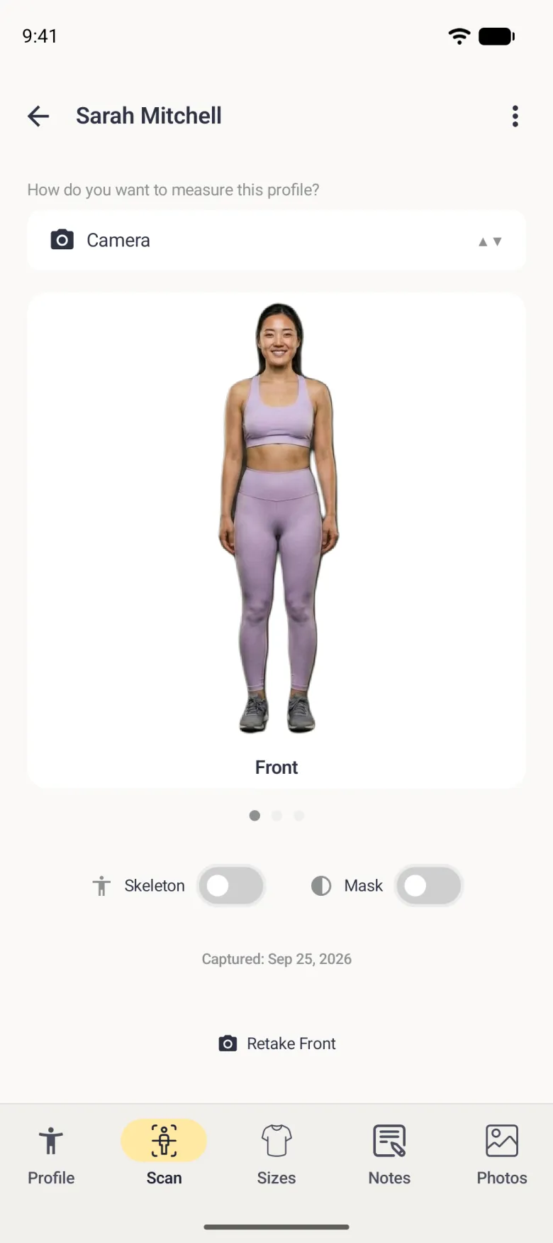 A Scan tab with Camera chosen in the mode dropdown, showing a front-facing photo of a woman in lilac activewear with the background removed and labelled Front, three page dots, Skeleton and Mask switches both off, a Captured date and a Retake Front link.