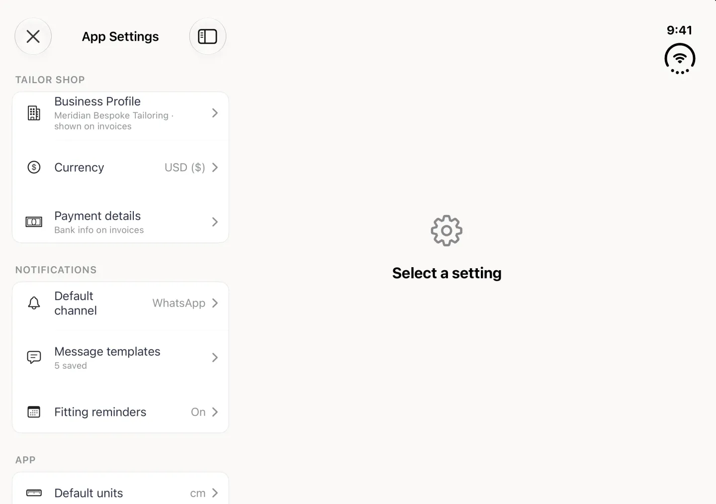 App Settings in landscape as a split view: on the left a close button, the title App Settings, a sidebar button and plain monochrome row icons: Business Profile (Meridian Bespoke Tailoring, shown on invoices), Currency USD ($) and Payment details (Bank info on invoices) under TAILOR SHOP, then Default channel WhatsApp, Message templates 5 saved and Fitting reminders On under NOTIFICATIONS, and the start of the APP section with Default units cm; on the right a gear icon and Select a setting until a row is chosen.