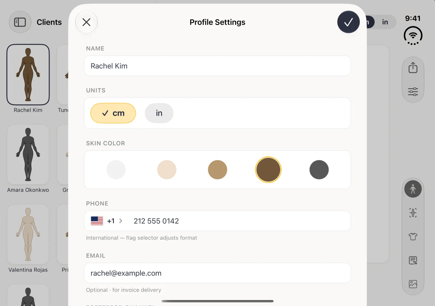 Profile Settings as a card over the dimmed client view in landscape, with a cross at the top left and a navy checkmark at the top right, the name Rachel Kim under NAME, cm and in buttons under UNITS with cm ticked, five skin tone circles under SKIN COLOR with brown ringed in gold, then PHONE +1 212 555 0142 and her email under EMAIL.
