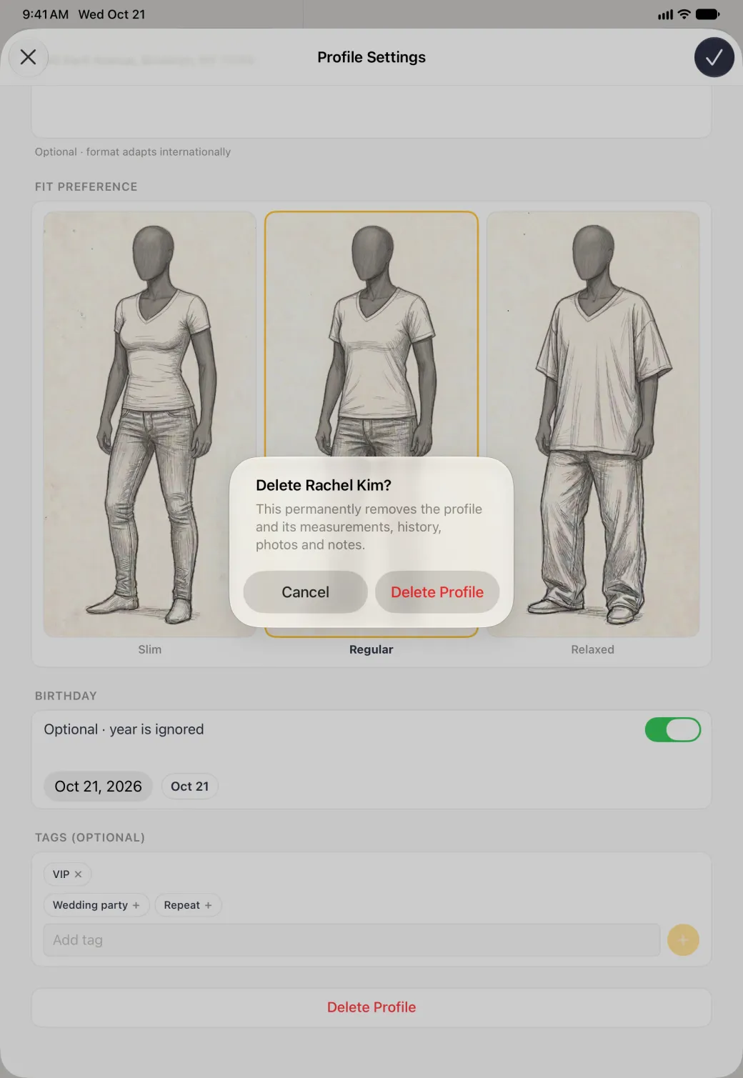 Alert centred on the dimmed full-width Profile Settings sheet, titled Delete Rachel Kim? and warning that this permanently removes the profile and its measurements, history, photos and notes, with Cancel and a red Delete Profile button, over the three Fit Preference sketches with Regular outlined, the Birthday switch on with an Oct 21, 2026 date, the Tags card with VIP applied and a full-width white Delete Profile card at the bottom.