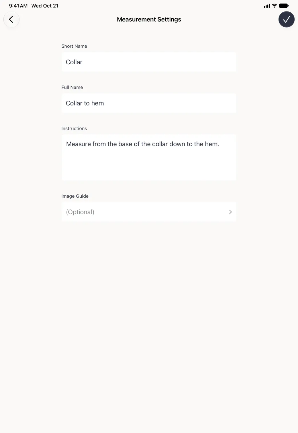 A Measurement Settings page on the iPad with Back at the top left and a navy checkmark at the top right, its fields in a centred column: Short Name Collar, Full Name Collar to hem, the instructions Measure from the base of the collar down to the hem., and an empty optional Image Guide row.