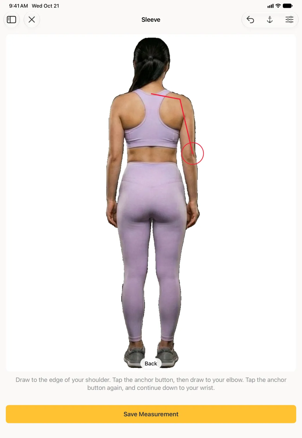 The same back view on the iPad with the red line now ending at the elbow, the final segment to the wrist gone, and the red target circle at the elbow.