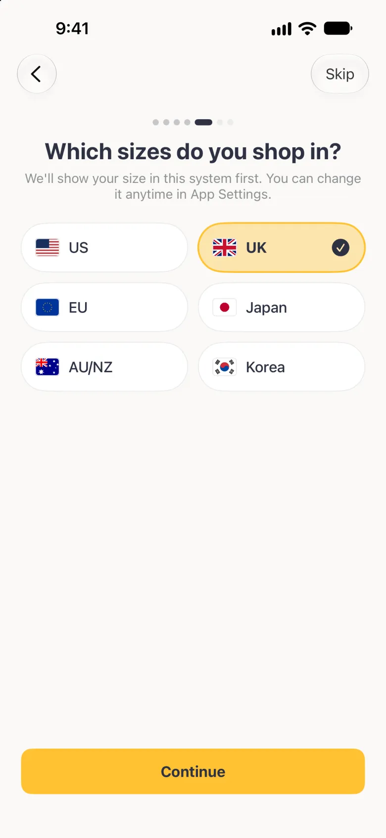 Which sizes do you shop in? step with six region buttons in two columns, US, UK, EU, Japan, AU/NZ and Korea, each with its flag, and UK highlighted in gold with a navy tick, above a gold Continue button; Back sits at the top left and Skip at the top right.