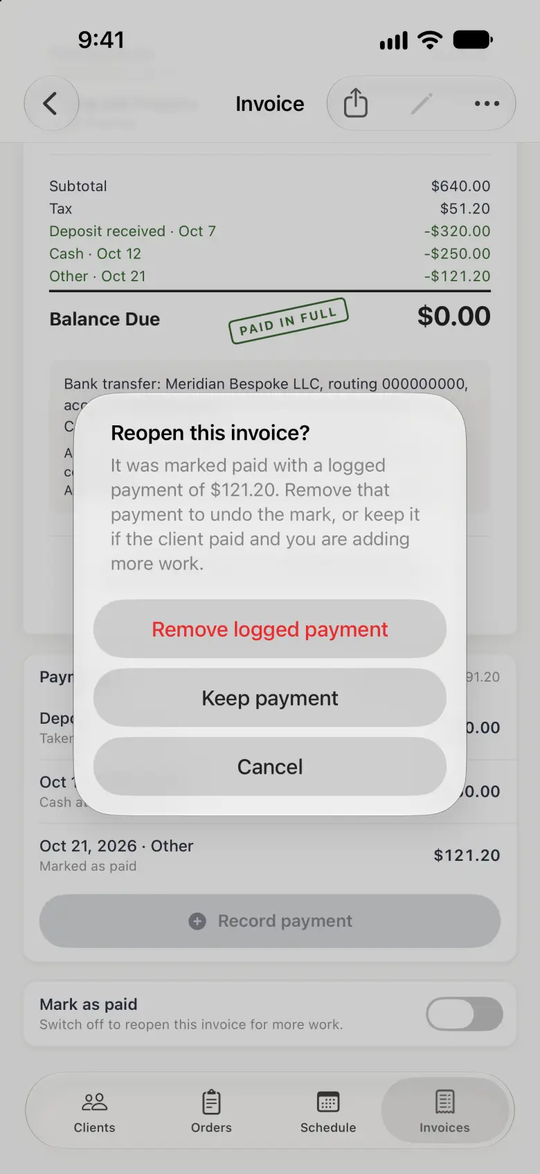 Invoice INV-2 dimmed behind an alert titled Reopen this invoice?, explaining that it was marked paid with a logged payment of $121.20 and offering three buttons: Remove logged payment in red, Keep payment and Cancel. The PAID IN FULL stamp and the Mark as paid switch, now off, show behind the alert.