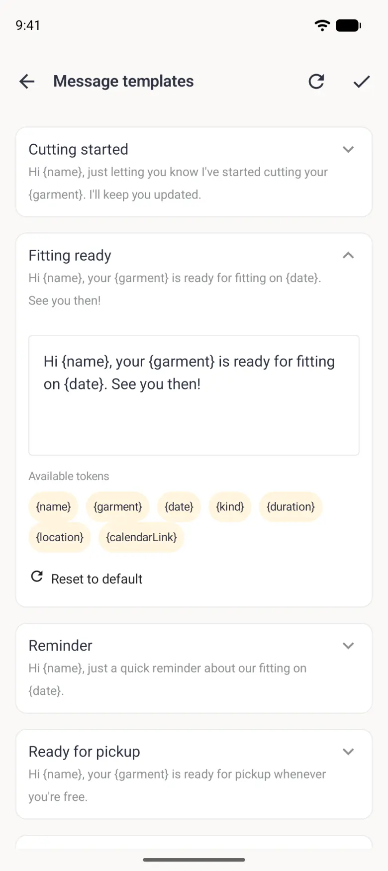 Expanded Fitting ready card with its one-line wording, an editable text box, an Available tokens legend of seven pale gold chips labelled name, garment, date, kind, duration, location and calendarLink wrapping over two rows, and a Reset to default link with a circular-arrow icon.