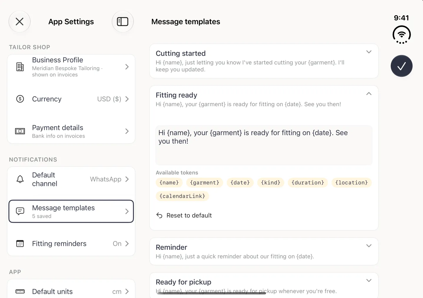 App Settings split view in landscape with the Message templates page on the right and the Fitting ready card expanded: an editable text box reading Hi {name}, your {garment} is ready for fitting on {date}. See you then., seven pale gold token chips under Available tokens labelled {name}, {garment}, {date}, {kind}, {duration}, {location} and {calendarLink} wrapping over two rows, and a Reset to default link with a back-arrow icon, between the collapsed Cutting started card above and the Reminder and Ready for pickup cards below.