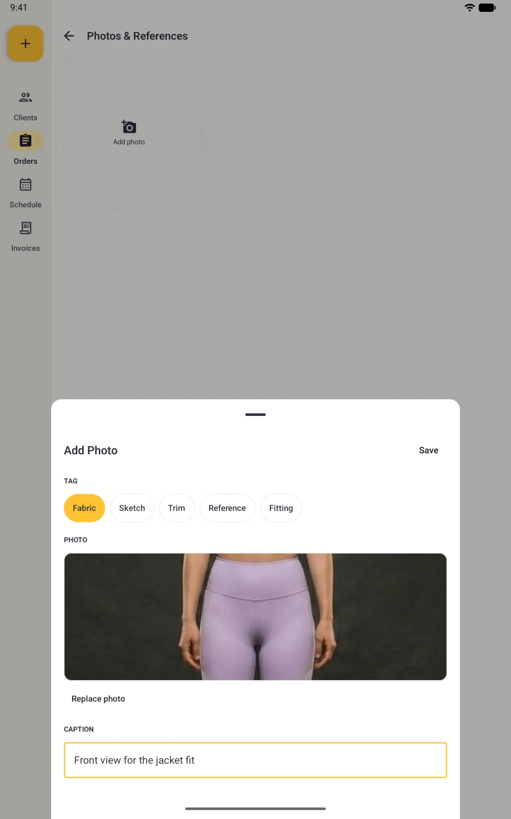 Add Photo sheet with the Fabric tag selected in gold, a wide photo box showing the middle of a front-facing body photo in lilac leggings, a Replace photo link, and a caption reading Front view for the jacket fit outlined in gold, with Save at the top right.