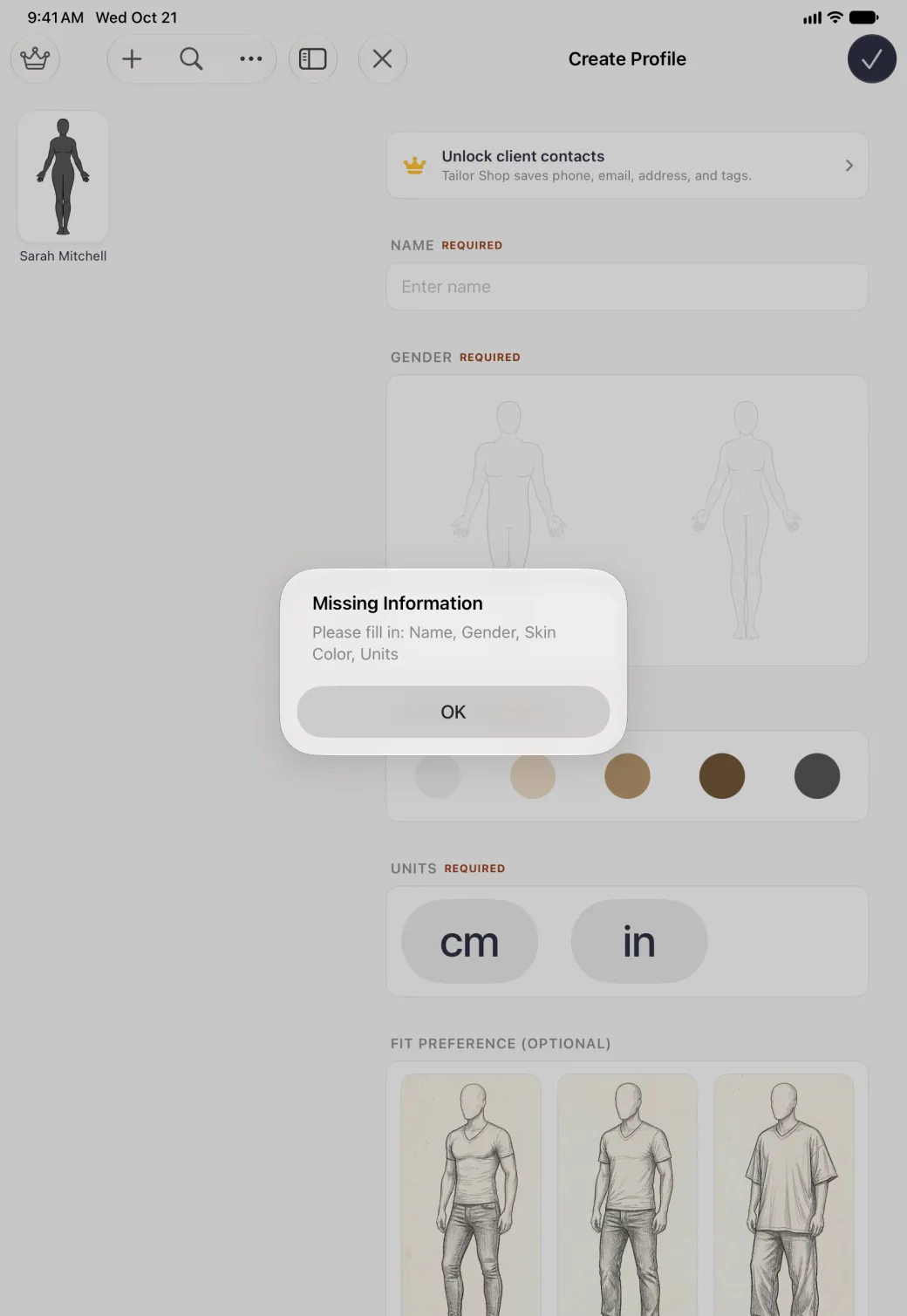 Alert centred on the dimmed split view, titled Missing Information and reading Please fill in: Name, Gender, Skin Color, Units, with a single OK button, over the empty Create Profile form on the right and the narrow profile list holding Sarah Mitchell on the left.