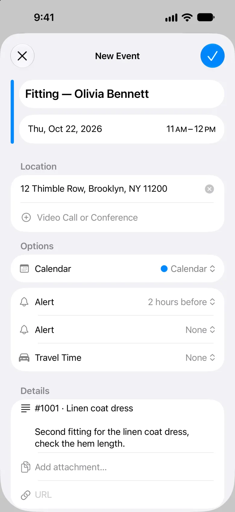 New Event sheet with a close button at the top left and a blue checkmark at the top right. The title reads Fitting, then a dash and Olivia Bennett, the date row reads Thu, Oct 22, 2026 with 11 AM to 12 PM, the location is 12 Thimble Row, Brooklyn, NY 11200, the Calendar row reads Calendar, the first Alert reads 2 hours before, and Details hold the order line #1001 · Linen coat dress and the note.