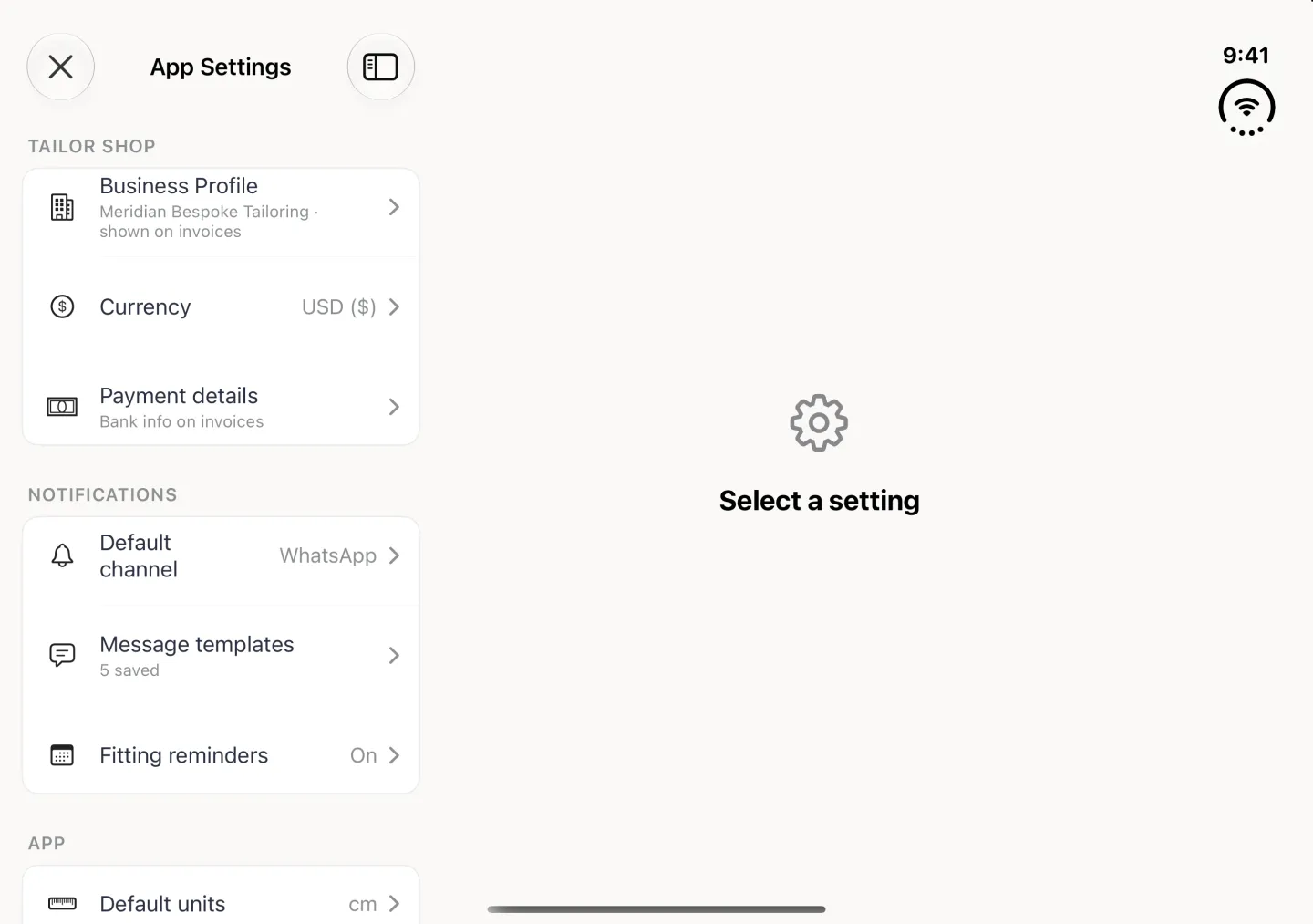 App Settings filling the open Duo in landscape as a split view, with a close button at the top left and the NOTIFICATIONS group in the settings list on the left listing Default channel set to WhatsApp, Message templates showing 5 saved and Fitting reminders On, between the TAILOR SHOP rows (Business Profile, Currency USD ($), Payment details) above and the APP rows starting with Default units cm below; the pane on the right shows a gear and Select a setting.